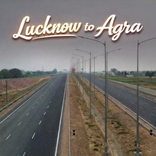 The image shows a wide, empty highway with street lamps lining both sides, stretching toward the horizon. The text "Lucknow to Agra" is displayed in elegant cursive at the top of the image. The scene has a quiet, open road feeling, suggesting a long journey.